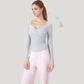 Long Sleeve Henley Activewear Top with Scoop Neckline and Streamlined Fitted Silhouette