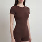 Short Sleeve One Piece Active Romper with Crew Neck Built In Padding Fitted Shorts and Smooth Stretch Fabric