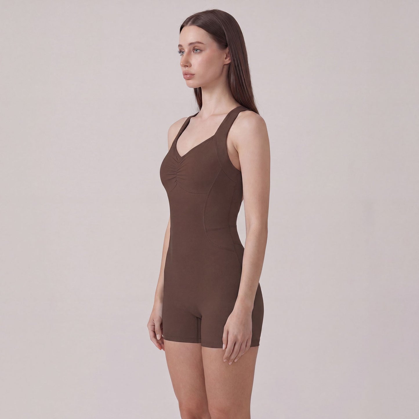 Sleeveless Active Romper with Cross Back Straps Ruched Bust Contour Seams and Fitted Shorts
