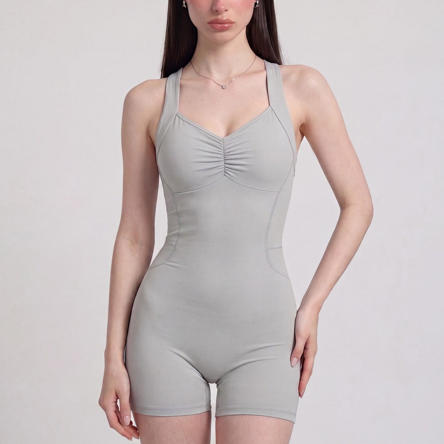 Sleeveless Active Romper with Cross Back Straps Ruched Bust Contour Seams and Fitted Shorts